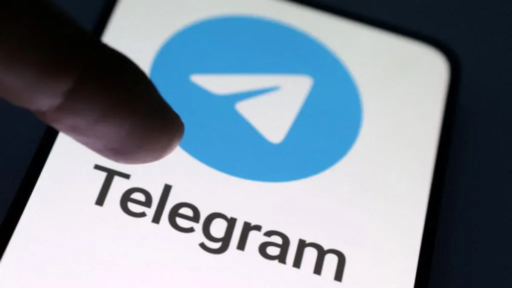 Telegram LOGO on a phone with a person hand