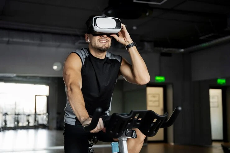 man doing indoor cycling with vr glasses