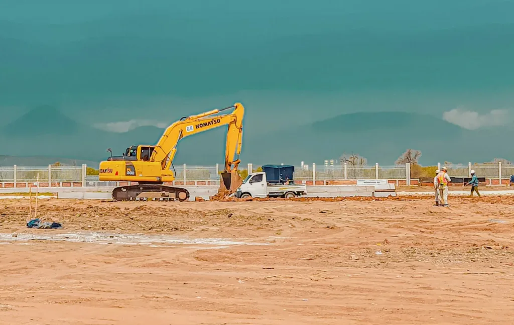 excavator on a plain deserted area with minerals